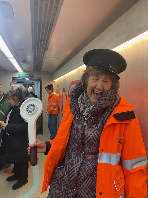 Woman laughing dressed in guards outfit at Railway 200 Southport Station